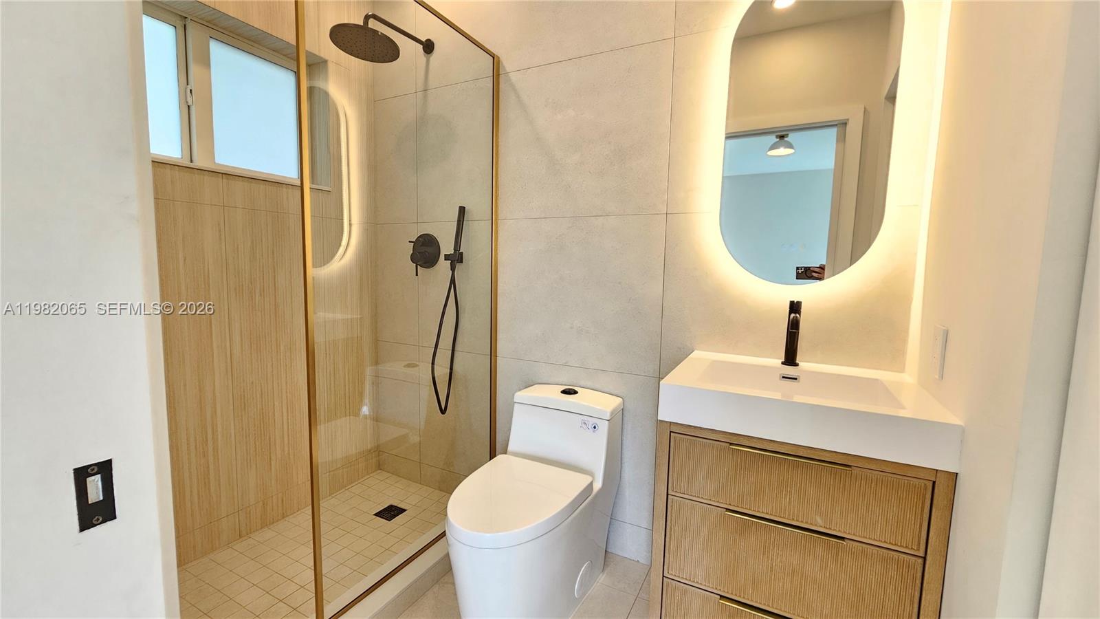 2365 Southwest 21st Avenue Miami, FL 33145 - Photo 52 of 56 a bathroom with a toilet a sink and shower