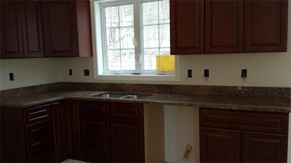1 Tom Casey Road Spencer, MA 01562 - Photo 12 of 16 a kitchen with a sink a stove cabinets and a window
