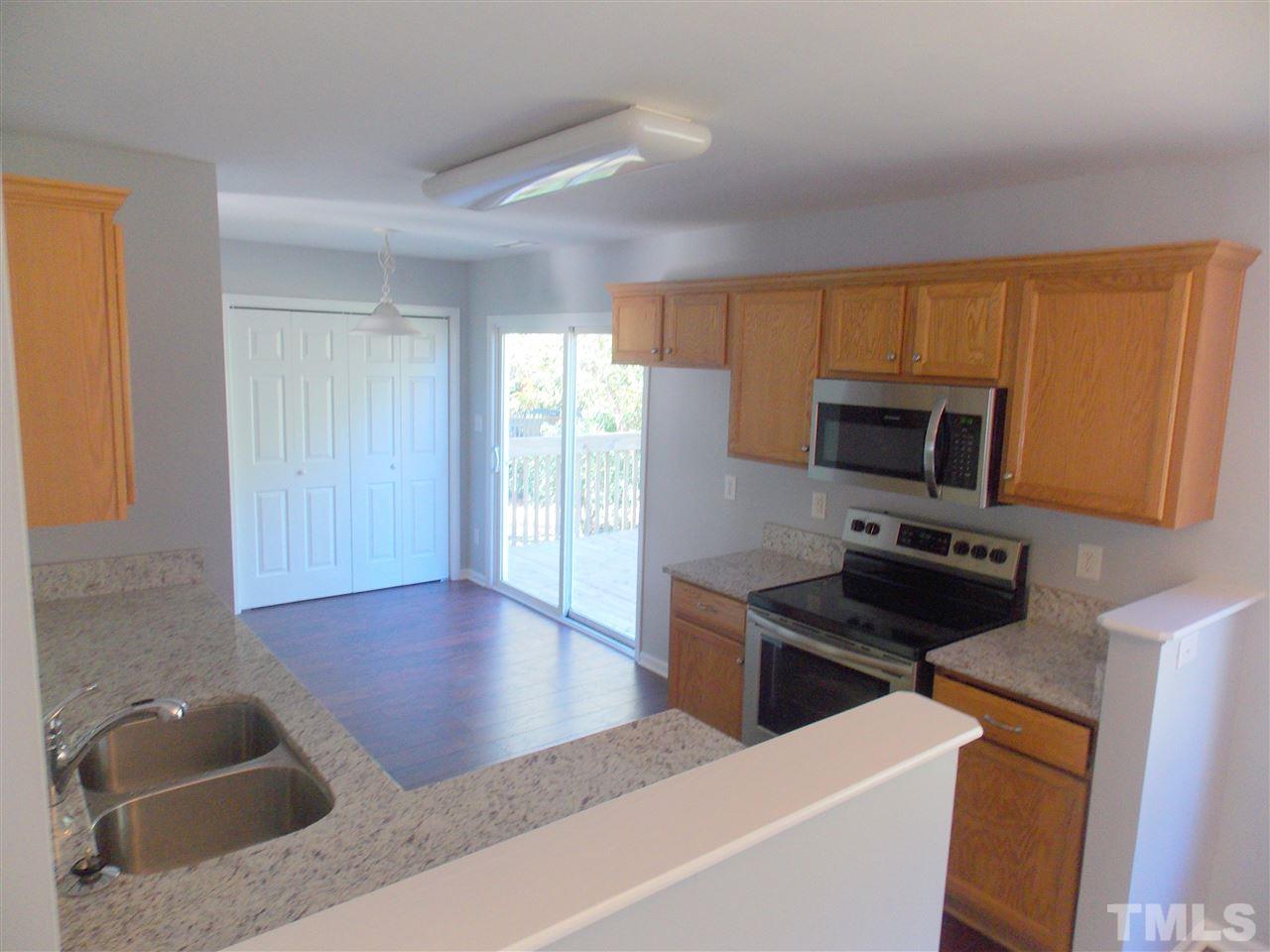 4101 Hopper Street Raleigh, NC 27616 - Photo 3 of 12 a kitchen with stainless steel appliances granite countertop a sink stove and microwave