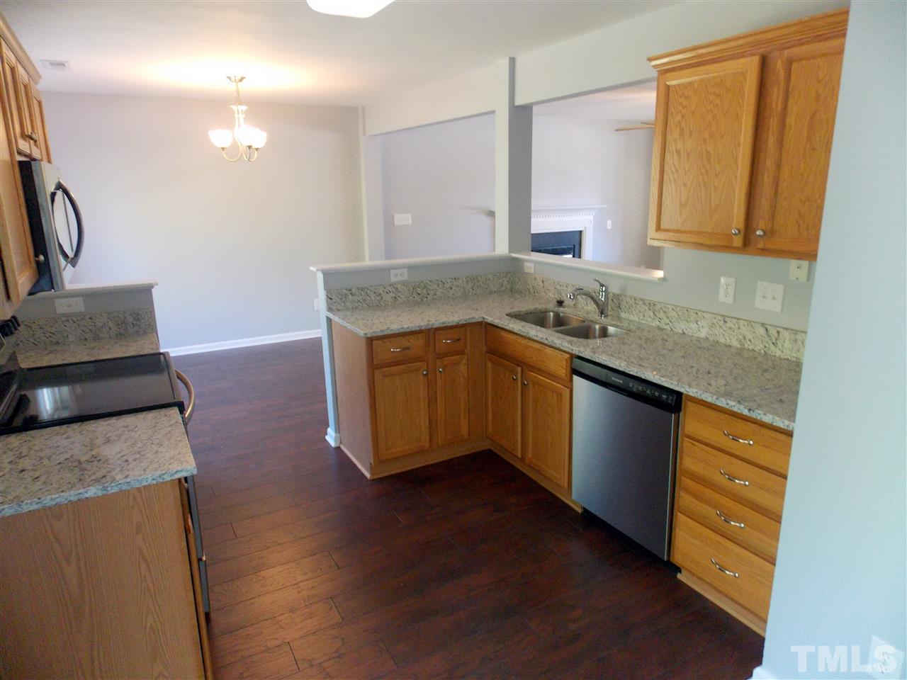 4101 Hopper Street Raleigh, NC 27616 - Photo 4 of 12 a kitchen with granite countertop a sink and a stove top oven