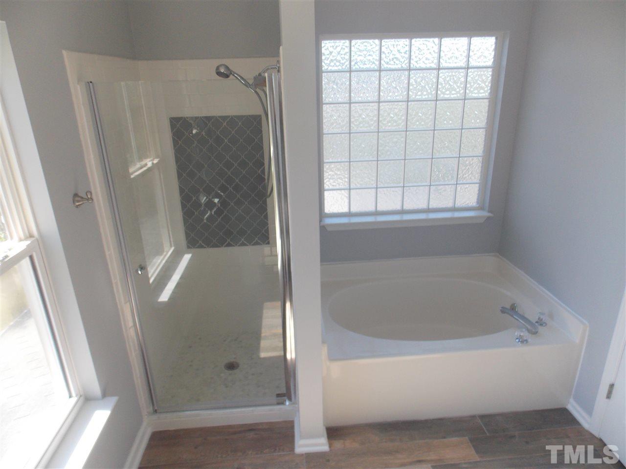 4101 Hopper Street Raleigh, NC 27616 - Photo 9 of 12 a bathroom with a bathtub and a shower