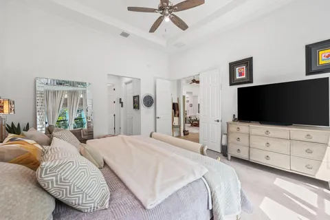 a bedroom with a bed and a flat screen tv in white walls