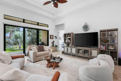 a living room with furniture and kitchen view