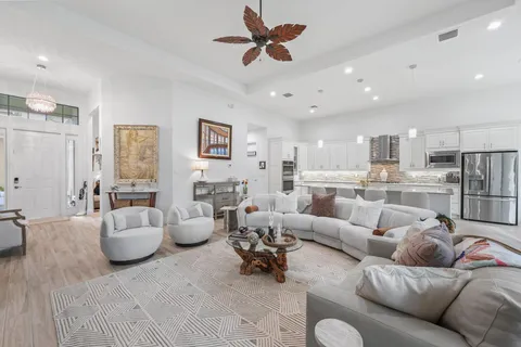 a large kitchen with stainless steel appliances granite countertop a lot of counter space and wooden floors
