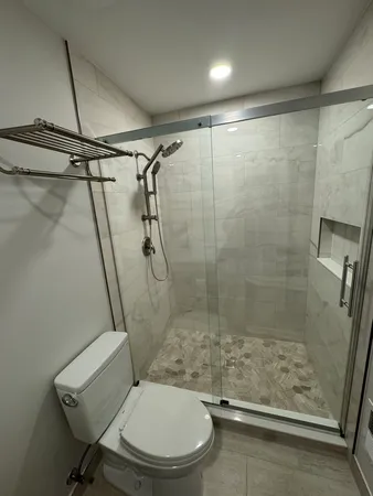 a bathroom with a toilet and a shower