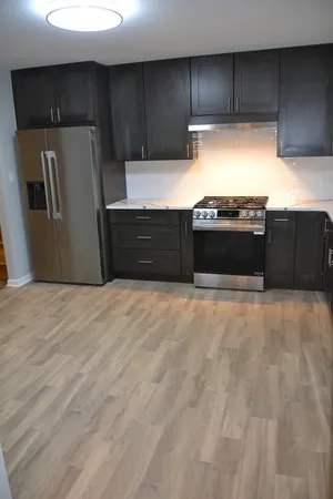 a kitchen with stainless steel appliances a refrigerator and a stove