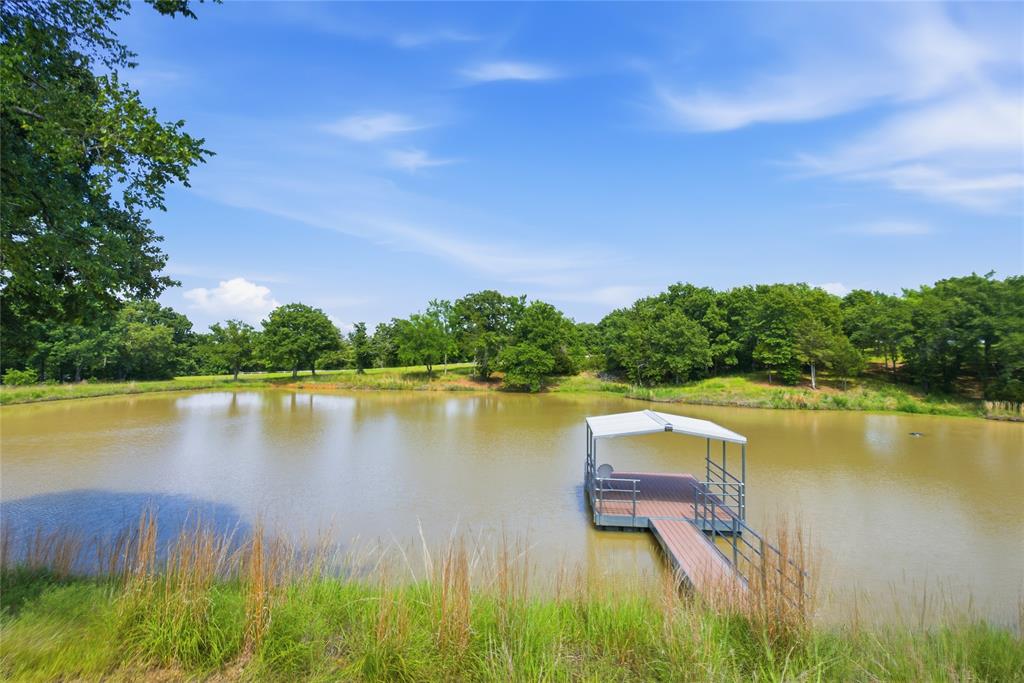 1073 Gordonville Road Gordonville, TX 76245 - Photo 3 of 38 An extensive pond with a covered dock with trees all around it invites you to spend some time relaxing.