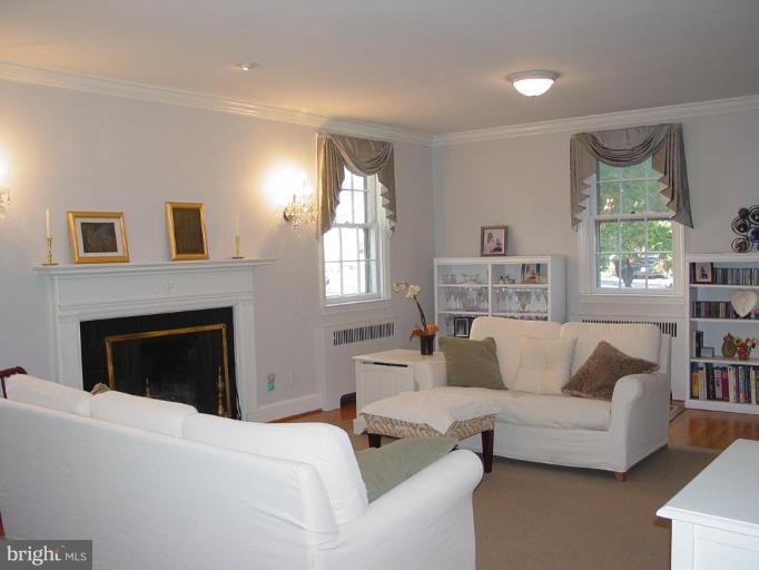 907 Kingston Road Baltimore, MD 21212 - Photo 2 of 23 Living room with hardwood floors & wood-burning fp