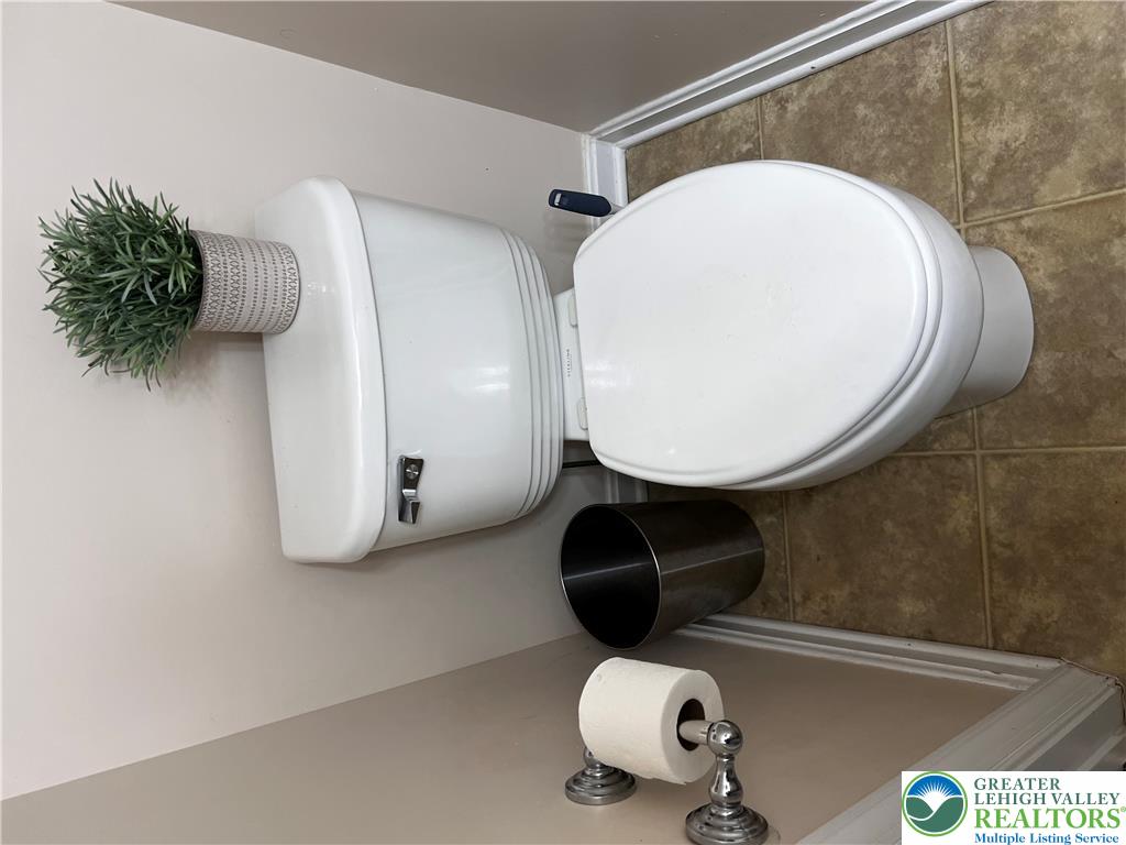 8549 Gateway Road Breinigsville, PA 18031 - Photo 15 of 26 Functional bathroom featuring a commode with practical tile flooring.