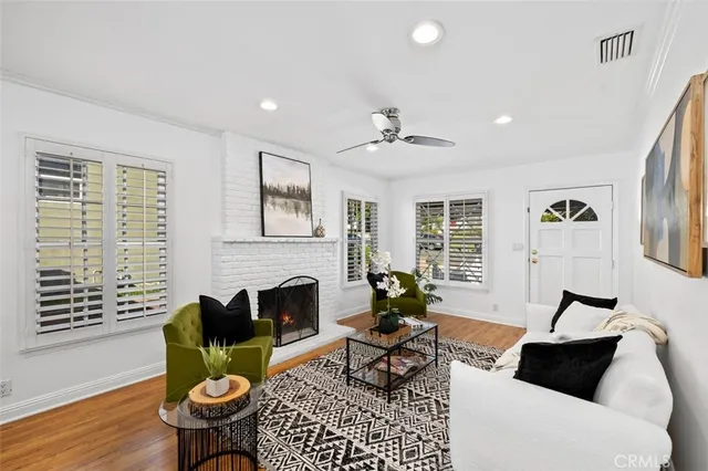 a living room with furniture a fireplace and a table