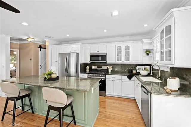a kitchen with refrigerator and cabinets