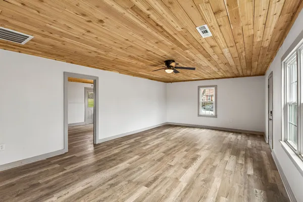 a view of empty room with wooden floor and cabinet