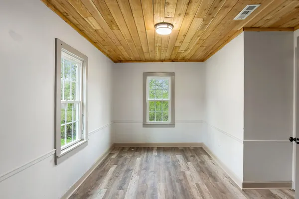 a view of a room with wooden floor