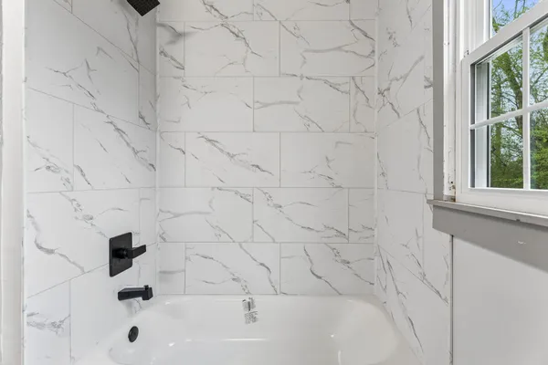 a bathroom with a bathtub and a shower