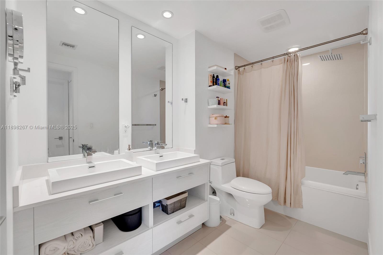 55 Southwest 9th Street, Unit 1802 Miami, FL 33130 - Photo 12 of 35 a bathroom with a sink a toilet and shower