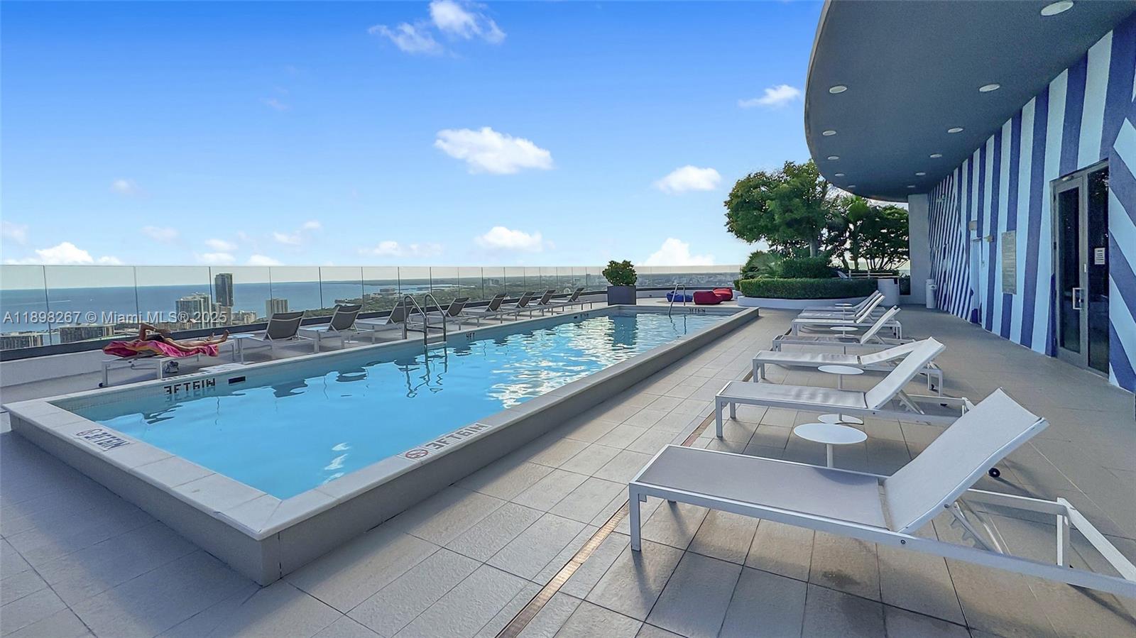 55 Southwest 9th Street, Unit 1802 Miami, FL 33130 - Photo 18 of 35 a view of a patio with chairs and tables