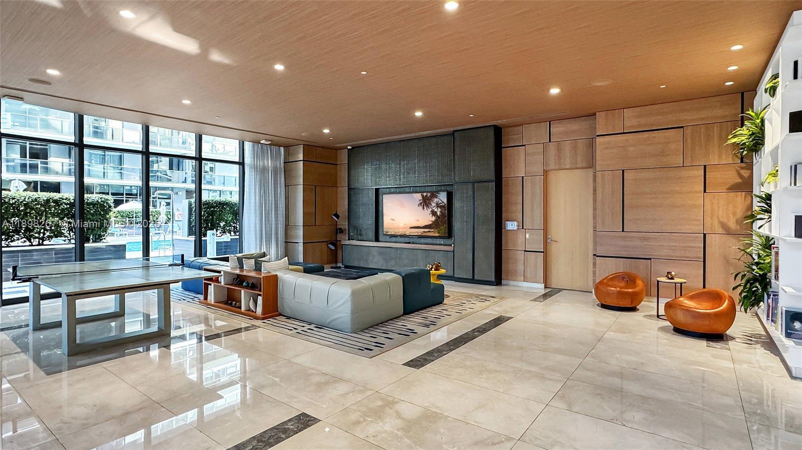 55 Southwest 9th Street, Unit 1802 Miami, FL 33130 - Photo 24 of 35 a living room with furniture a large window and a sink