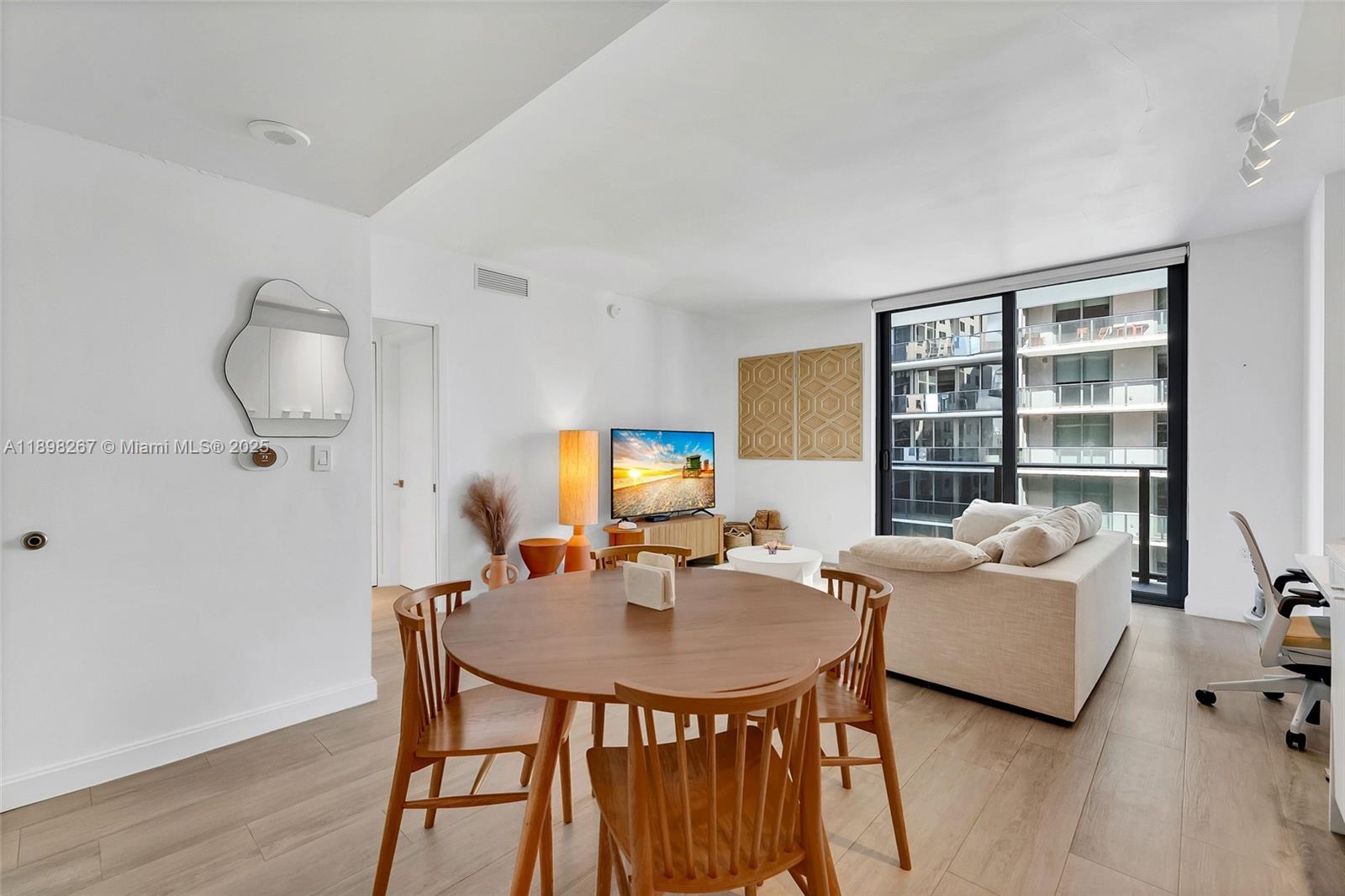 55 Southwest 9th Street, Unit 1802 Miami, FL 33130 - Photo 5 of 35 a living room with furniture and a table