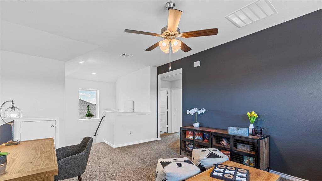 500 Range Road Caddo Mills, TX 75135 - Photo 20 of 35 Upper-level flexible space featuring a ceiling fan with integrated lighting, a contrasting accent wall, and plush carpeting
