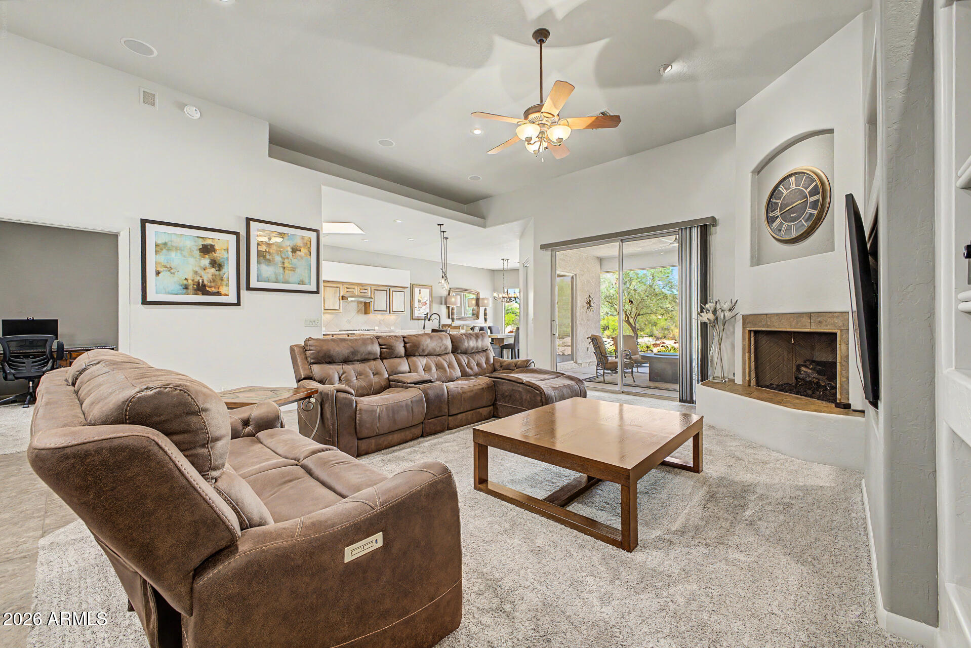 27909 North Quail Spring Road Rio Verde, AZ 85263 - Photo 9 of 52 a living room with furniture and a fireplace