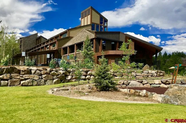 a front view of a house with a yard table and chairs