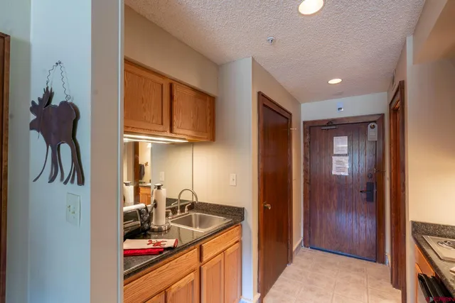 a kitchen with stainless steel appliances granite countertop a sink and cabinets
