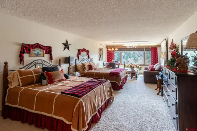 a bedroom with three beds and a window