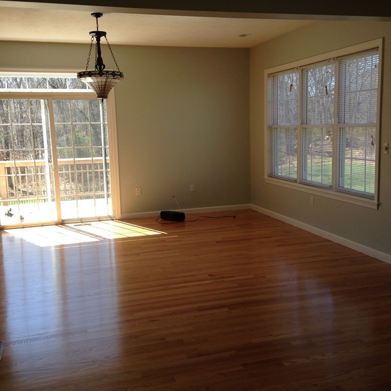 48 Independence Lane Ashland, MA 01721 - Photo 12 of 30 a view of an empty room with wooden floor and a window