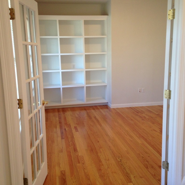 48 Independence Lane Ashland, MA 01721 - Photo 13 of 30 a view of an empty room with wooden floor and a window