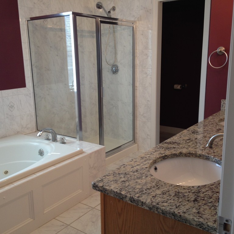 48 Independence Lane Ashland, MA 01721 - Photo 17 of 30 a bathroom with a granite countertop sink a mirror and shower