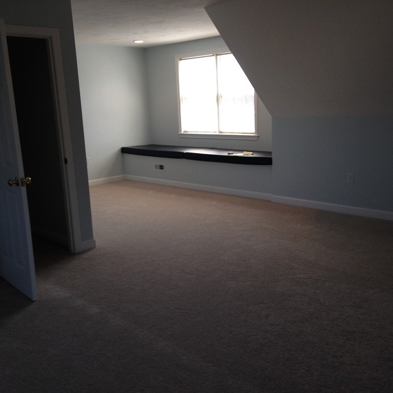 48 Independence Lane Ashland, MA 01721 - Photo 22 of 30 an empty room with wooden floor and windows