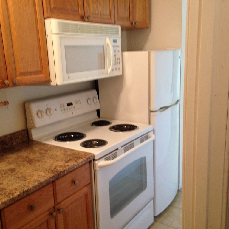 48 Independence Lane Ashland, MA 01721 - Photo 23 of 30 a stove top oven sitting inside of a kitchen