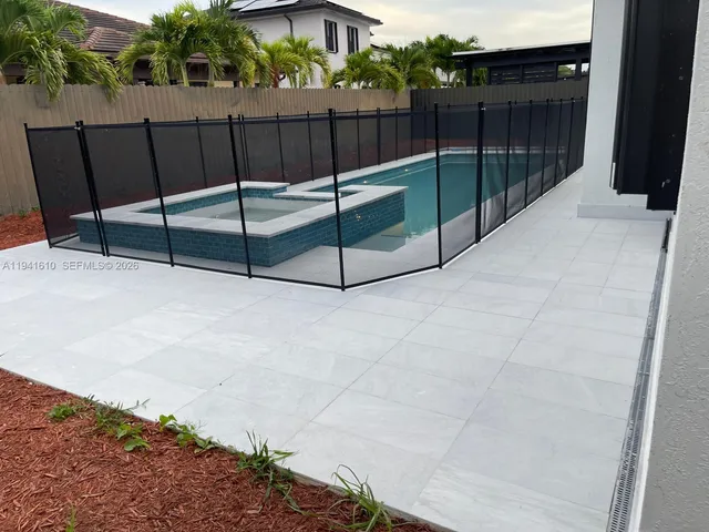 a view of a house with backyard and porch