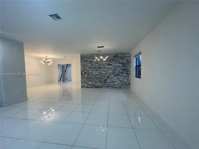 a view of a kitchen with a sink and cabinets