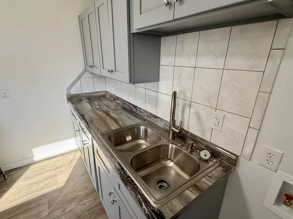 a stove top oven sitting inside of a kitchen