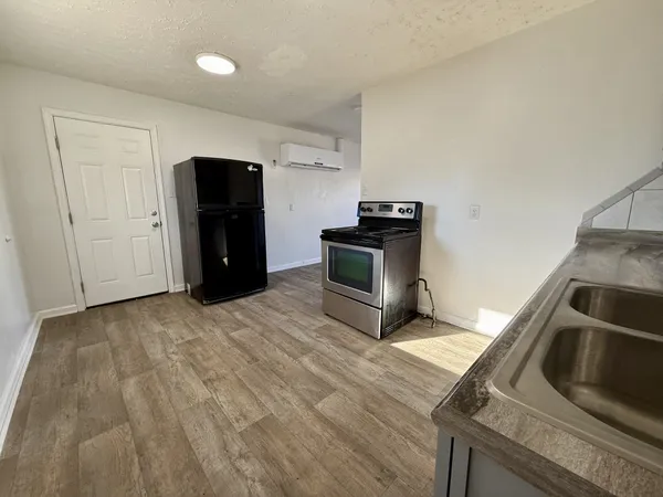a kitchen with a refrigerator and a sink
