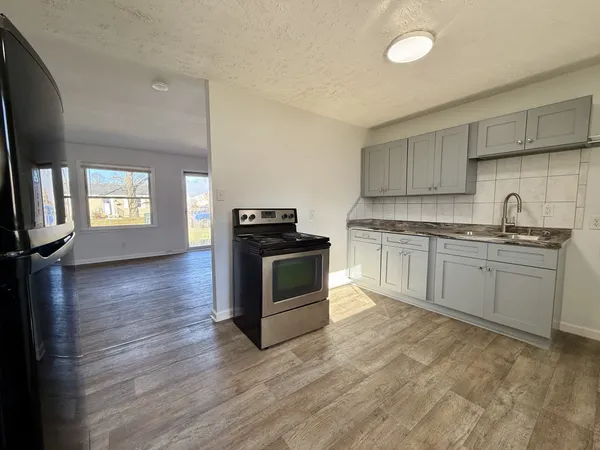 a kitchen with a stove top oven and sink