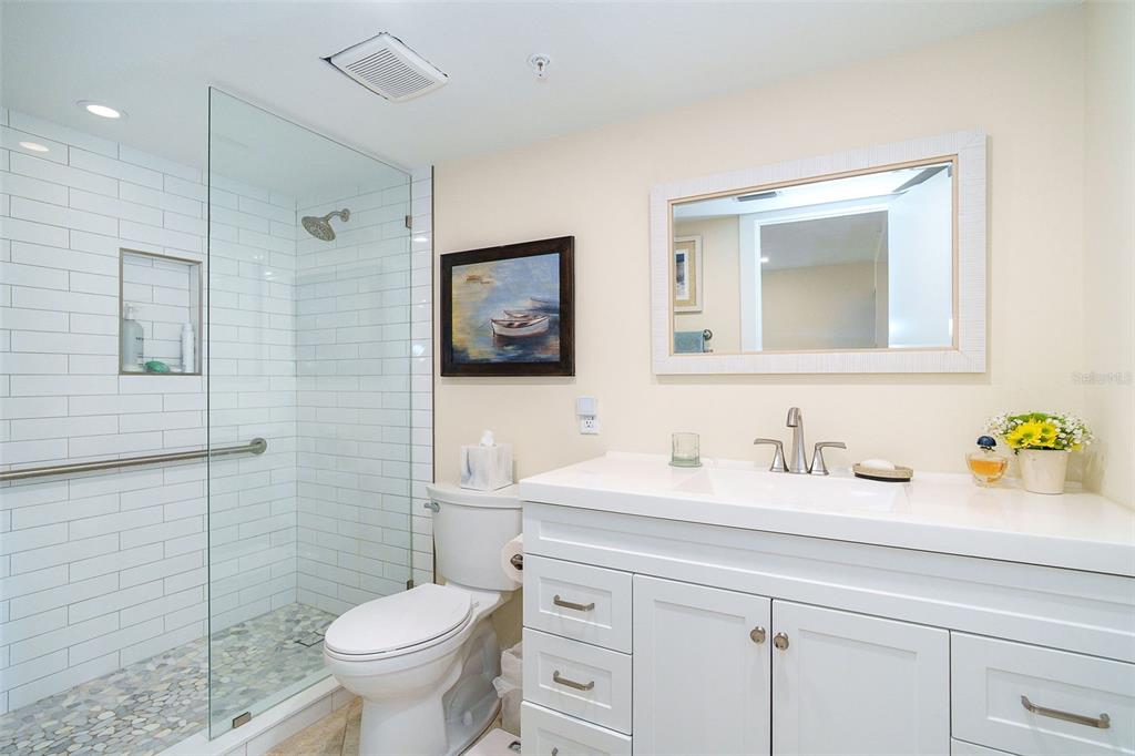 9200 Little Gasparilla, Unit 403 Boca Grande, FL 33921 - Photo 17 of 38 a bathroom with a toilet sink and mirror