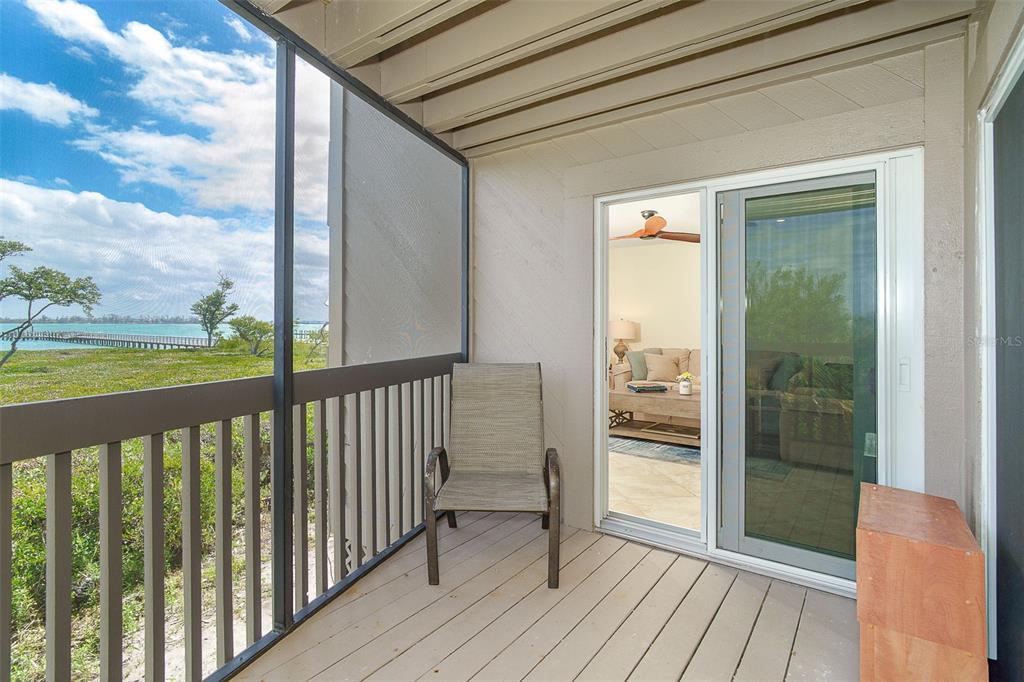 9200 Little Gasparilla, Unit 403 Boca Grande, FL 33921 - Photo 18 of 38 a view of a balcony with wooden floor
