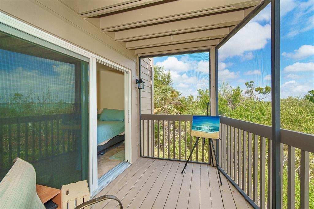 9200 Little Gasparilla, Unit 403 Boca Grande, FL 33921 - Photo 19 of 38 a view of a balcony with wooden floor