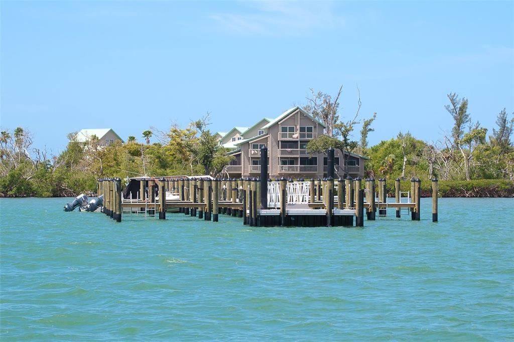 9200 Little Gasparilla, Unit 403 Boca Grande, FL 33921 - Photo 20 of 38 a view of a house with a yard and sitting area
