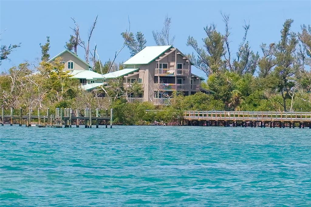 9200 Little Gasparilla, Unit 403 Boca Grande, FL 33921 - Photo 23 of 38 a front view of a house with a yard