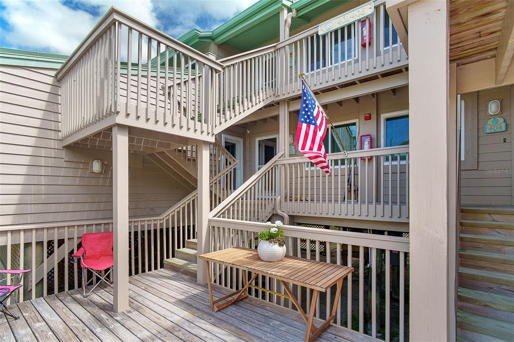9200 Little Gasparilla, Unit 403 Boca Grande, FL 33921 - Photo 24 of 38 a view of a house with wooden deck