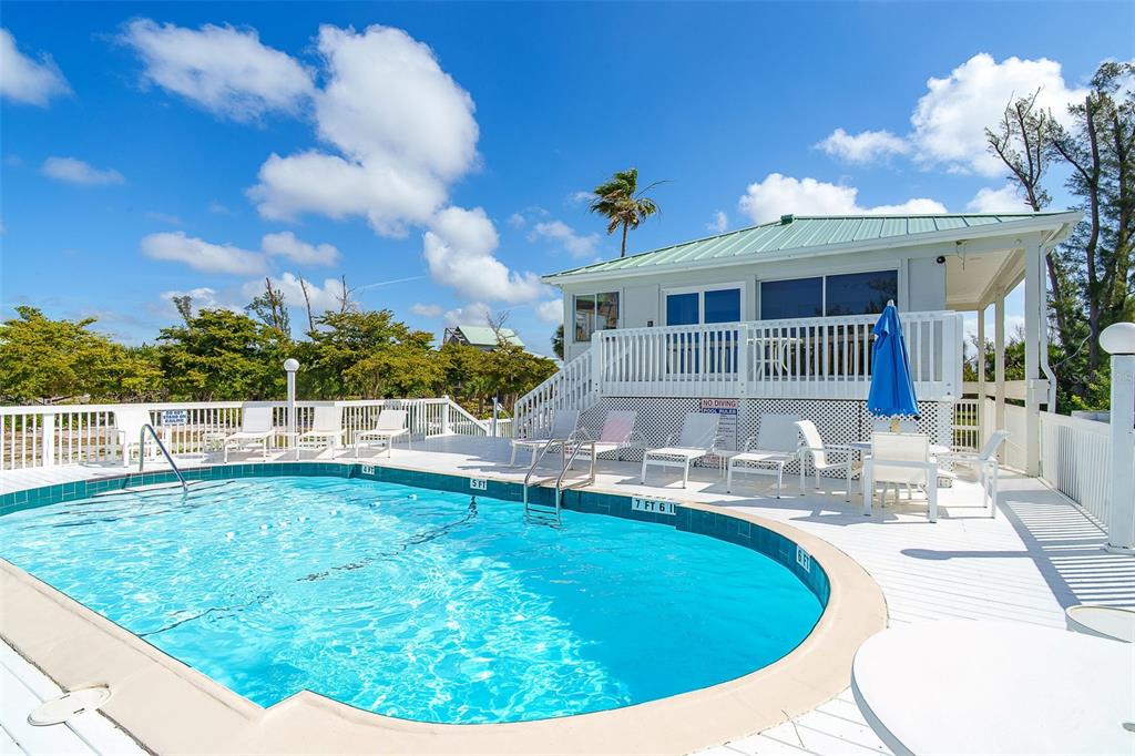 9200 Little Gasparilla, Unit 403 Boca Grande, FL 33921 - Photo 26 of 38 a view of house with swimming pool outdoor seating