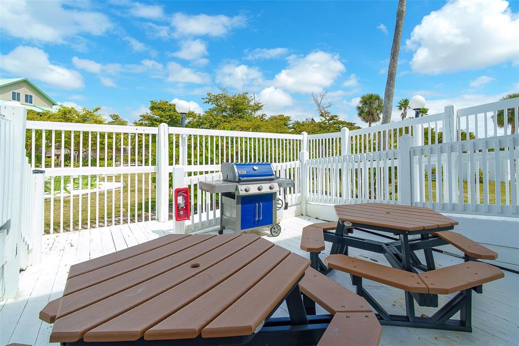 9200 Little Gasparilla, Unit 403 Boca Grande, FL 33921 - Photo 27 of 38 a view of a chairs and table on the deck