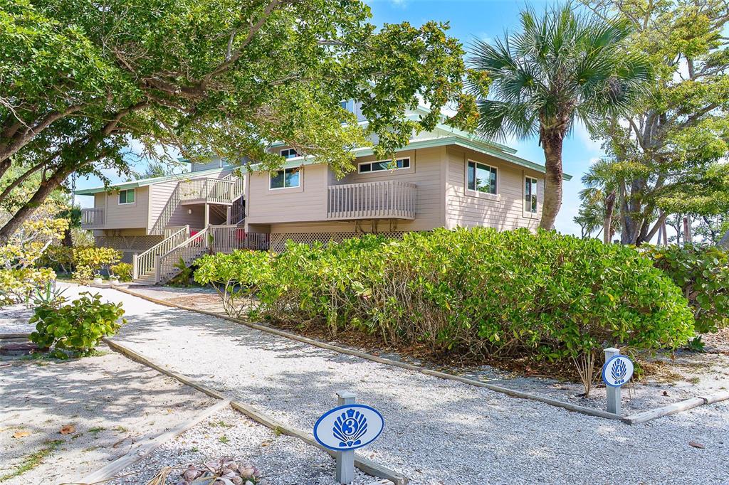9200 Little Gasparilla, Unit 403 Boca Grande, FL 33921 - Photo 3 of 38 a front view of a house with garden