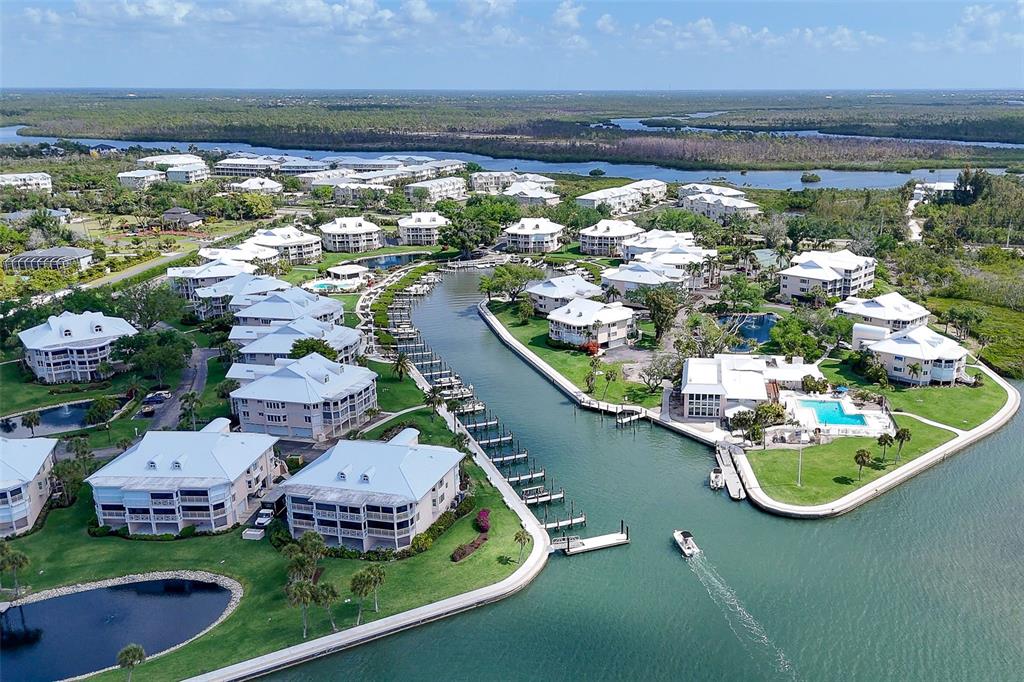 9200 Little Gasparilla, Unit 403 Boca Grande, FL 33921 - Photo 37 of 38 a view of a lake with a house swimming pool and outdoor seating