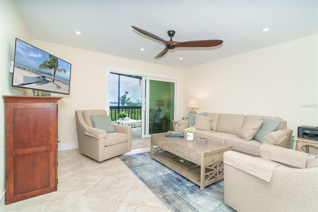 9200 Little Gasparilla, Unit 403 Boca Grande, FL 33921 - Photo 6 of 38 a living room with furniture and a large window