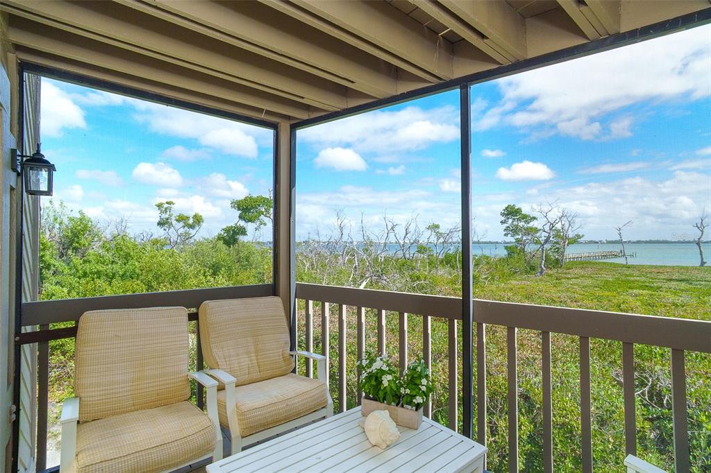 9200 Little Gasparilla, Unit 403 Boca Grande, FL 33921 - Photo 7 of 38 a view of a balcony with wooden floor