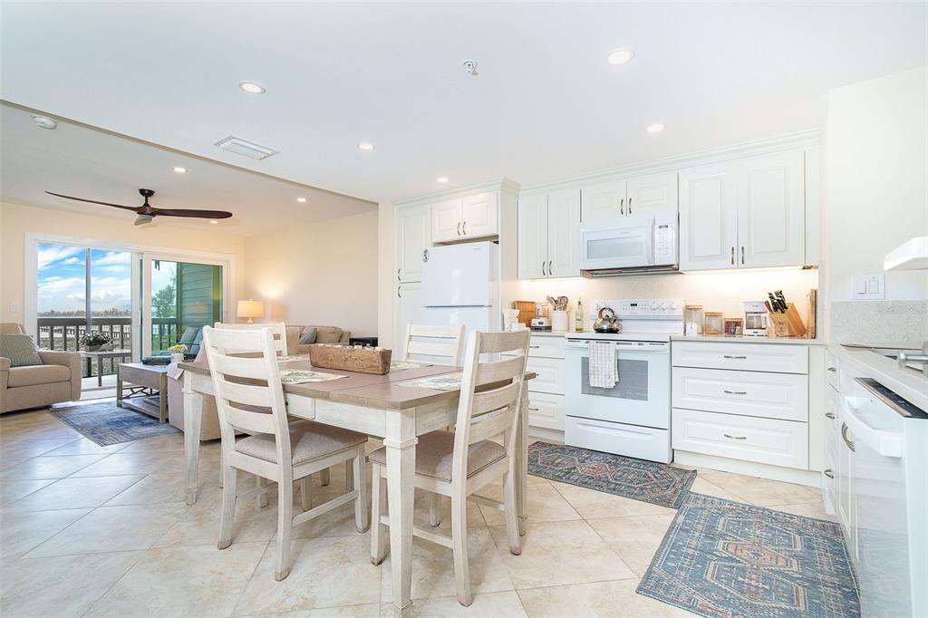 9200 Little Gasparilla, Unit 403 Boca Grande, FL 33921 - Photo 8 of 38 a kitchen with a dining table chairs and view living room